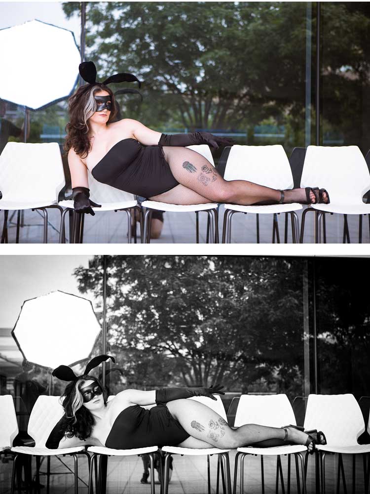 Woman in bunny costume poses on chairs by glass wall, styled with mask, gloves, and heels.
